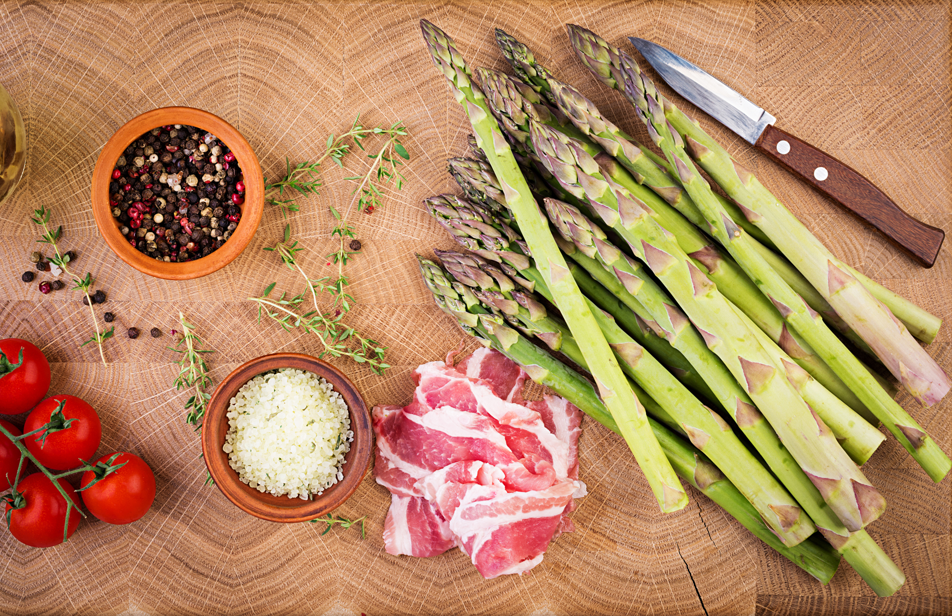 Fresh green asparagus and bacon on a rustic wooden table with copy space. Top view Fresh green asparagus and bacon on a rustic wooden table with copy space. Top view